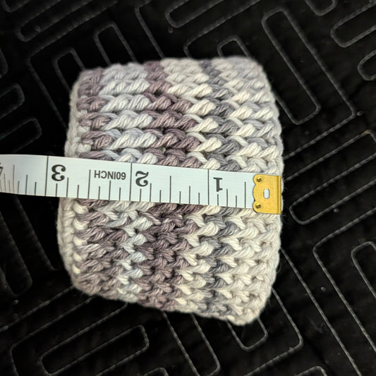 Knitted item with a measuring tape on a textured black surface