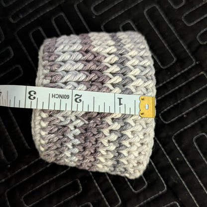 Knitted item with a measuring tape on a textured black surface